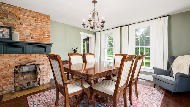 5377 Moots Run Rd, Alexandria, OH 43001 - dining room featuring a brick fireplace, a chandelier, and dark wood-style flooring