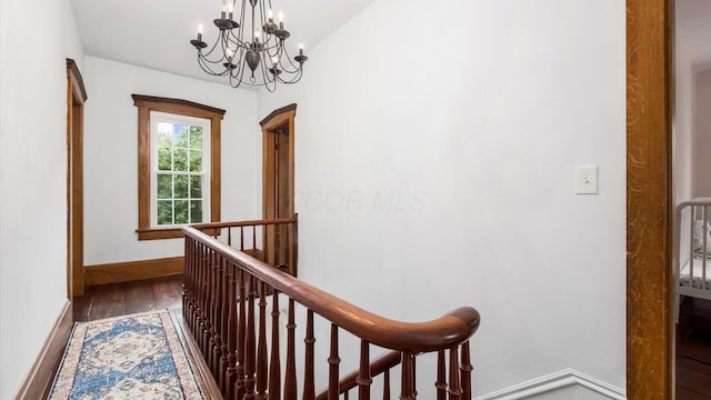 5377 Moots Run Rd, Alexandria, OH 43001 - hall with dark wood finished floors, a chandelier, and an upstairs landing