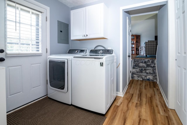 922 Afton Rd, Columbus, OH 43221 - laundry area featuring electric panel, washer and dryer, light wood finished floors, and cabinet space