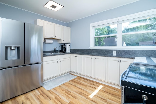 922 Afton Rd, Columbus, OH 43221 - kitchen featuring stainless steel fridge, crown molding, white cabinets, light wood-style floors, and black electric range