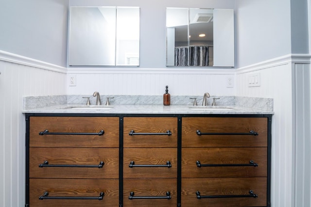 922 Afton Rd, Columbus, OH 43221 - full bathroom featuring double vanity, wainscoting, and a decorative wall