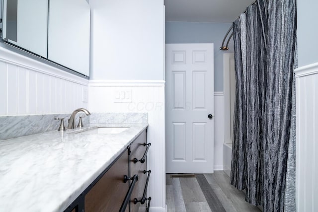 922 Afton Rd, Columbus, OH 43221 - full bath with wood finished floors, vanity, and shower / bath combination with curtain