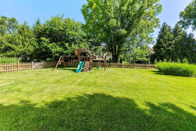 4884 Alston Grove Dr, Westerville, OH 43082 - fenced backyard with a playground and view of wooded area