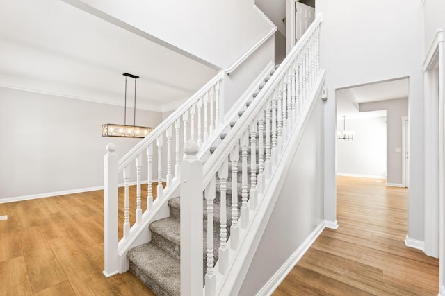4884 Alston Grove Dr, Westerville, OH 43082 - staircase with a chandelier, wood finished floors, and a high ceiling
