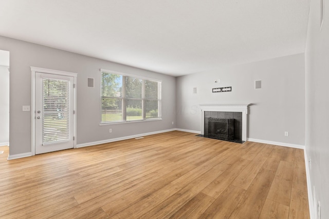 4884 Alston Grove Dr, Westerville, OH 43082 - unfurnished living room featuring light wood finished floors and a tile fireplace