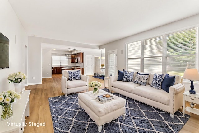 4884 Alston Grove Dr, Westerville, OH 43082 - living room with light wood-type flooring and a chandelier
