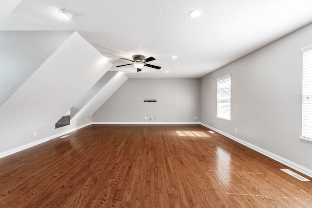 4884 Alston Grove Dr, Westerville, OH 43082 - additional living space featuring dark wood-type flooring, recessed lighting, ceiling fan, vaulted ceiling, and a textured ceiling