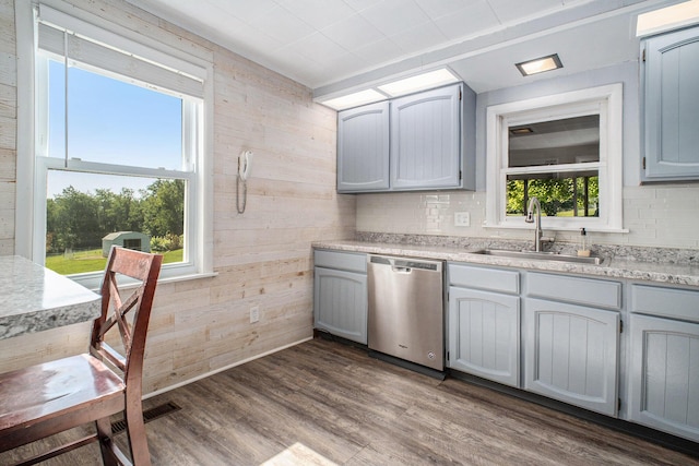 2883 Tucker Rd, Lucas, OH 44843 - kitchen featuring stainless steel dishwasher, wood walls, dark wood-style floors, light countertops, and gray cabinets