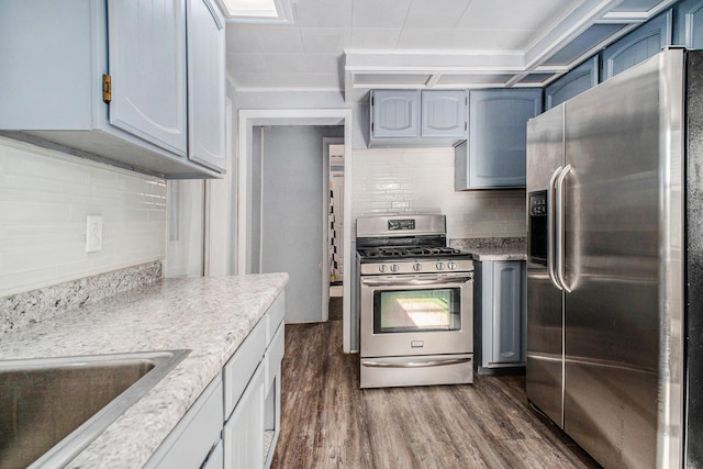 2883 Tucker Rd, Lucas, OH 44843 - kitchen featuring stainless steel appliances, blue cabinets, tasteful backsplash, dark wood-style floors, and ornamental molding