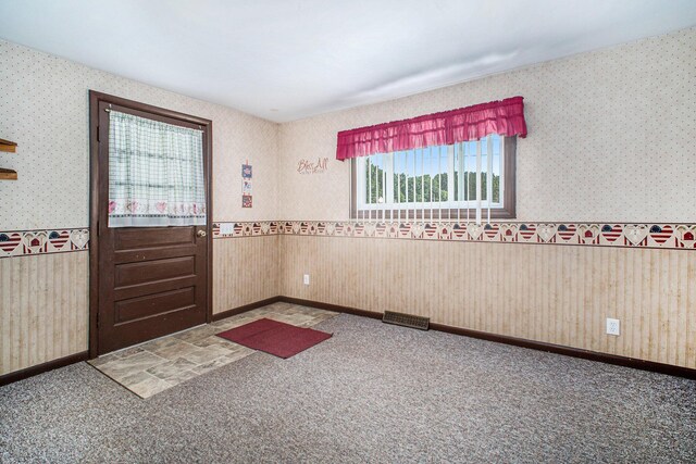 2883 Tucker Rd, Lucas, OH 44843 - spare room featuring wallpapered walls, carpet floors, and a wainscoted wall