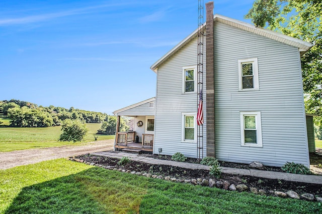 2883 Tucker Rd, Lucas, OH 44843 - rear view of property with a lawn, covered porch, and a chimney