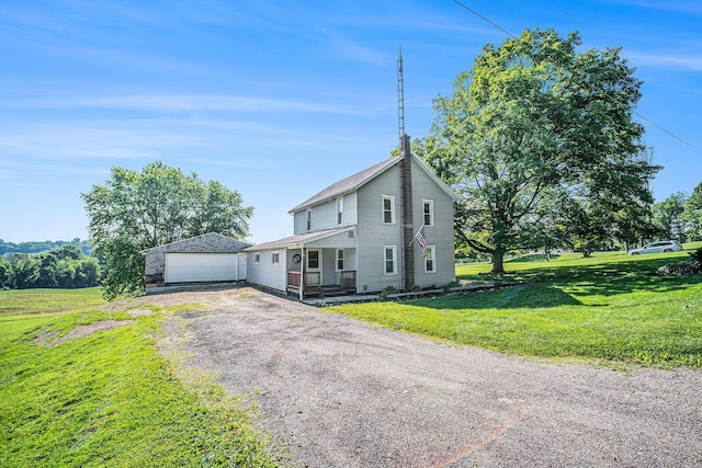 2883 Tucker Rd, Lucas, OH 44843 - view of front of house featuring a front yard, a detached garage, and a porch