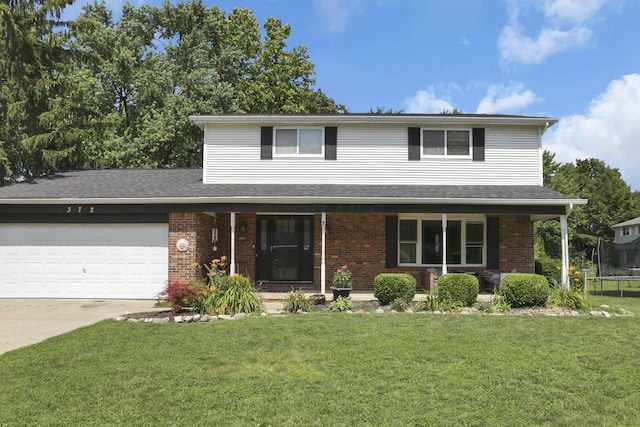 372 Depauw Ct, Columbus, OH 43230 - traditional-style house with a porch, a front yard, an attached garage, and brick siding