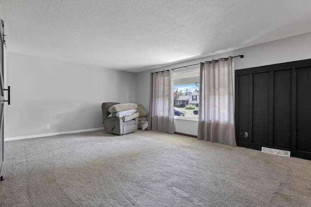372 Depauw Ct, Columbus, OH 43230 - unfurnished room with a textured ceiling, carpet flooring, and a barn door
