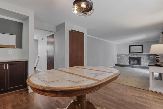 372 Depauw Ct, Columbus, OH 43230 - dining area with dark wood finished floors and a fireplace