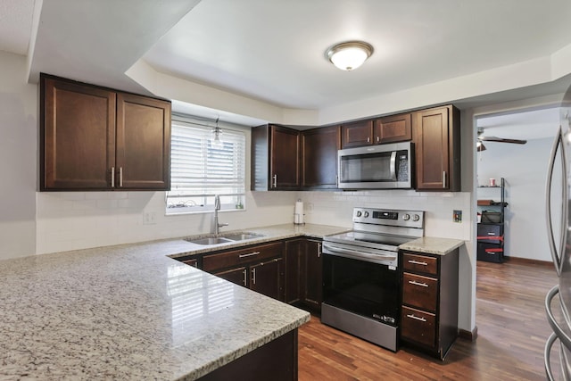 372 Depauw Ct, Columbus, OH 43230 - kitchen with stainless steel appliances, backsplash, dark brown cabinetry, light stone countertops, and wood finished floors