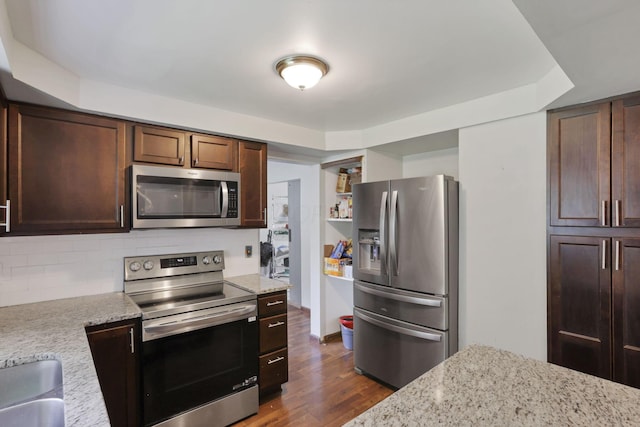 372 Depauw Ct, Columbus, OH 43230 - kitchen with stainless steel appliances, tasteful backsplash, dark wood finished floors, dark brown cabinetry, and light stone countertops