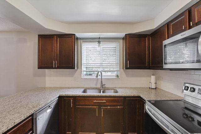 372 Depauw Ct, Columbus, OH 43230 - kitchen with appliances with stainless steel finishes, decorative backsplash, light stone counters, and dark brown cabinets