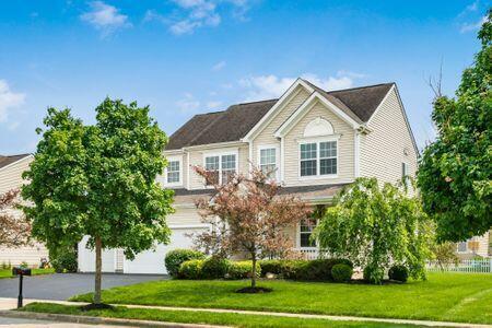 1883 Caplinger Dr, Grove City, OH 43123 - view of front of house with a front lawn, an attached garage, and driveway