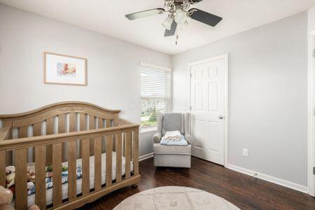 1883 Caplinger Dr, Grove City, OH 43123 - bedroom with wood finished floors, a nursery area, and a ceiling fan