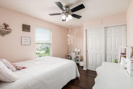 1883 Caplinger Dr, Grove City, OH 43123 - bedroom featuring dark wood-type flooring, a closet, and a ceiling fan