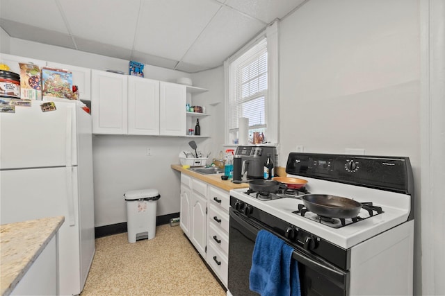 1561 Glenn Ave, Columbus, OH 43212 - kitchen with white appliances, a drop ceiling, white cabinetry, light countertops, and open shelves
