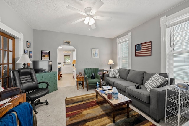 1561 Glenn Ave, Columbus, OH 43212 - living area featuring arched walkways, carpet flooring, ceiling fan, and a textured ceiling