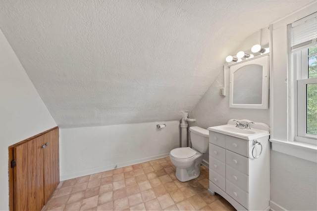1561 Glenn Ave, Columbus, OH 43212 - bathroom featuring a textured ceiling, vanity, and vaulted ceiling
