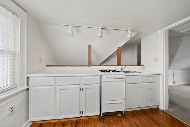 1561 Glenn Ave, Columbus, OH 43212 - kitchen featuring white range with gas cooktop, rail lighting, dark wood-style flooring, white cabinetry, and light countertops