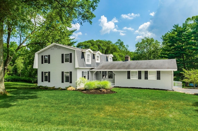 277 Mill Race Rd, Granville, OH 43023 - colonial inspired home featuring a front lawn, a gambrel roof, a chimney, and roof with shingles
