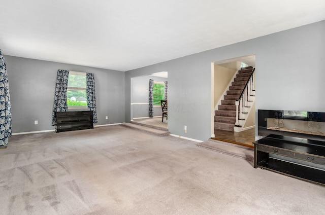 277 Mill Race Rd, Granville, OH 43023 - unfurnished living room with stairway and carpet flooring