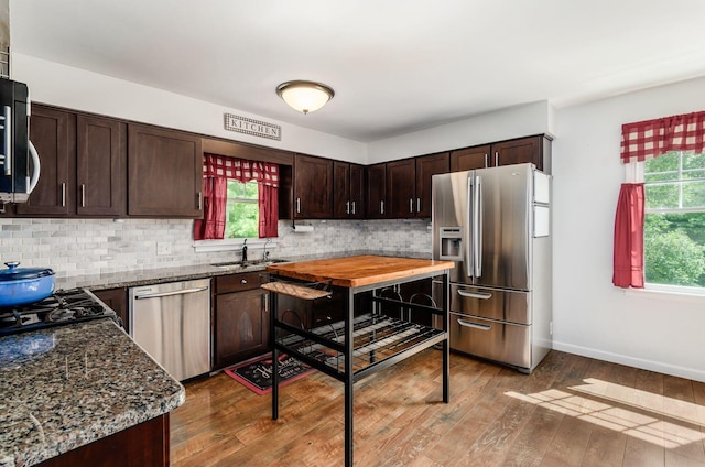 277 Mill Race Rd, Granville, OH 43023 - kitchen featuring stainless steel appliances, dark brown cabinets, decorative backsplash, and wood finished floors