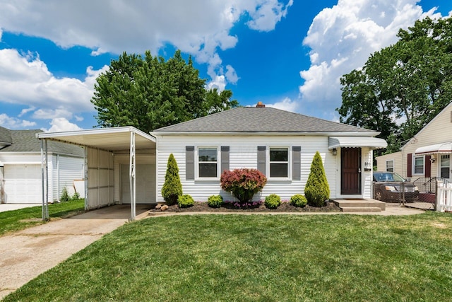 854 E Weber Rd, Columbus, OH 43211 - view of front of house with driveway, a front lawn, a carport, and roof with shingles