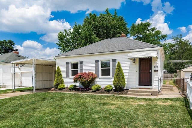 854 E Weber Rd, Columbus, OH 43211 - view of front of house with roof with shingles, a carport, an outbuilding, and a garage