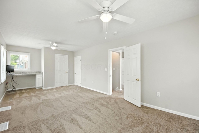 87 N Warren Ave, Columbus, OH 43204 - unfurnished living room featuring a ceiling fan, light colored carpet, and an office area