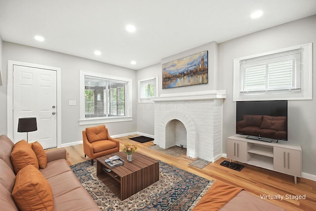 87 N Warren Ave, Columbus, OH 43204 - living area with wood finished floors, recessed lighting, and a brick fireplace