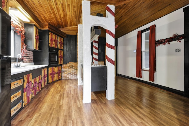 27380 Miller Rd, Rockbridge, OH 43149 - kitchen with wooden ceiling, light wood-style floors, light countertops, and black appliances