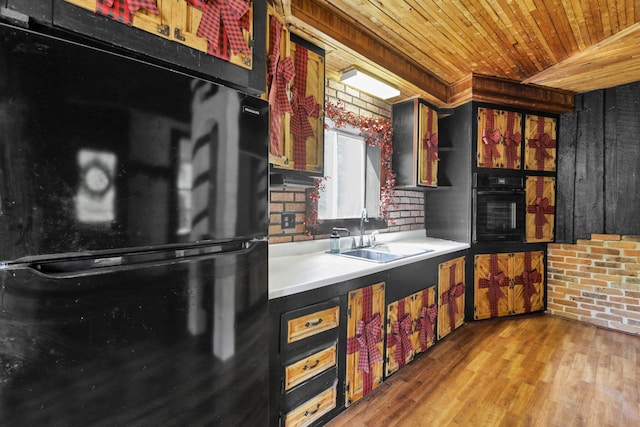27380 Miller Rd, Rockbridge, OH 43149 - kitchen with black appliances, wood ceiling, wood finished floors, light countertops, and brick wall