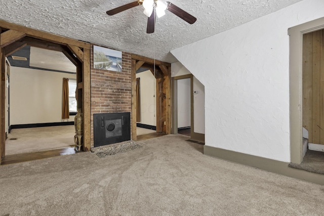 27380 Miller Rd, Rockbridge, OH 43149 - unfurnished living room with carpet floors, a textured ceiling, a ceiling fan, and a fireplace