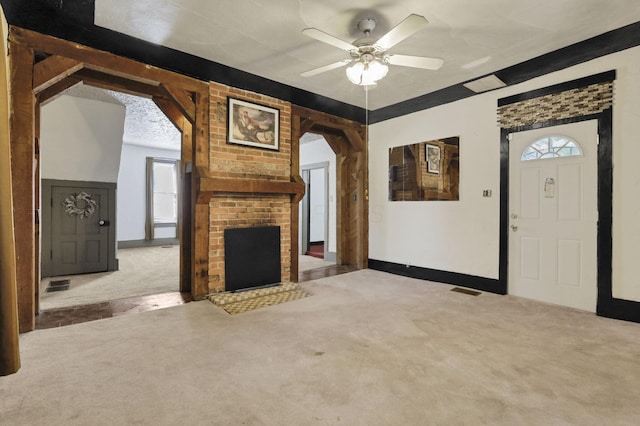 27380 Miller Rd, Rockbridge, OH 43149 - unfurnished living room featuring carpet, a ceiling fan, arched walkways, and a fireplace