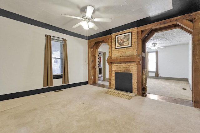 27380 Miller Rd, Rockbridge, OH 43149 - unfurnished living room with ceiling fan, carpet flooring, and a brick fireplace