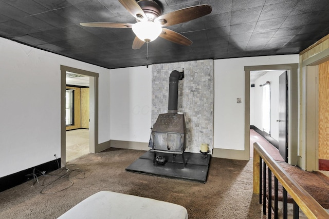 27380 Miller Rd, Rockbridge, OH 43149 - living room featuring a wood stove, carpet flooring, and a ceiling fan