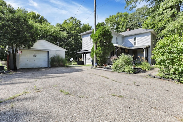 27380 Miller Rd, Rockbridge, OH 43149 - view of side of home with an outbuilding, a detached garage, and a chimney
