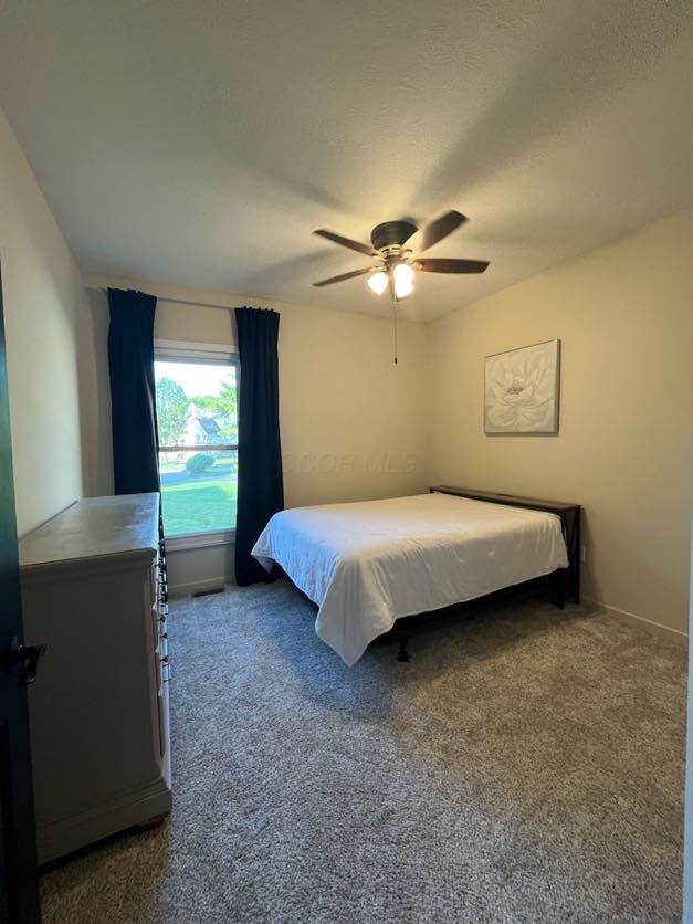 450 Village Ridge Ct, Powell, OH 43065 - bedroom with dark carpet and a ceiling fan