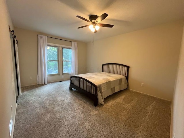 450 Village Ridge Ct, Powell, OH 43065 - bedroom with carpet flooring, a barn door, and a ceiling fan