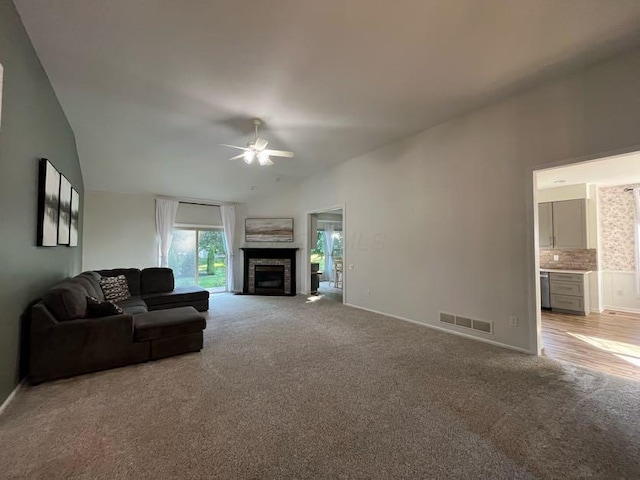 450 Village Ridge Ct, Powell, OH 43065 - living area with light carpet, ceiling fan, lofted ceiling, and a fireplace