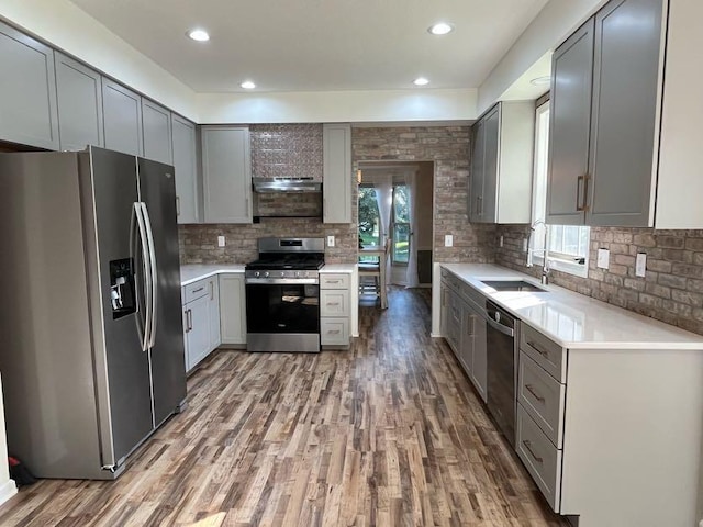 450 Village Ridge Ct, Powell, OH 43065 - kitchen with appliances with stainless steel finishes, gray cabinetry, wood finished floors, light countertops, and recessed lighting