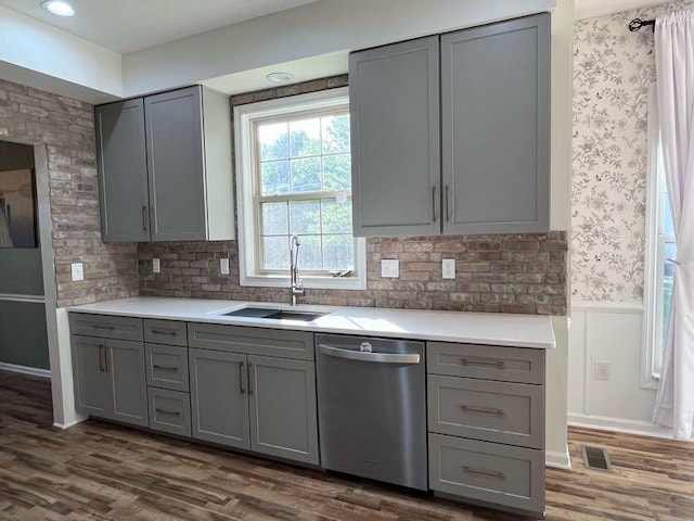450 Village Ridge Ct, Powell, OH 43065 - kitchen featuring stainless steel dishwasher, gray cabinetry, light countertops, a wainscoted wall, and wallpapered walls