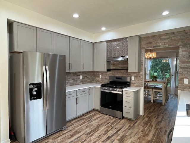 450 Village Ridge Ct, Powell, OH 43065 - kitchen with stainless steel appliances, gray cabinets, under cabinet range hood, light countertops, and recessed lighting
