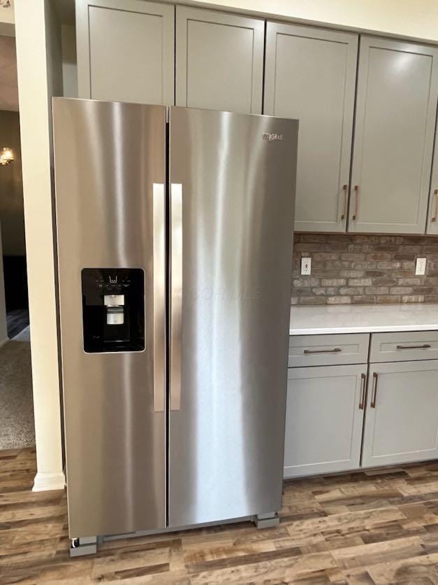450 Village Ridge Ct, Powell, OH 43065 - kitchen featuring stainless steel fridge with ice dispenser, gray cabinetry, light wood finished floors, light countertops, and tasteful backsplash
